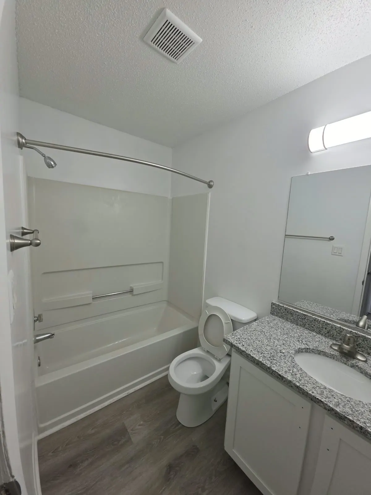Tub and shower surround with a granite vanity top, bathroom remodeling in Hampton, VA