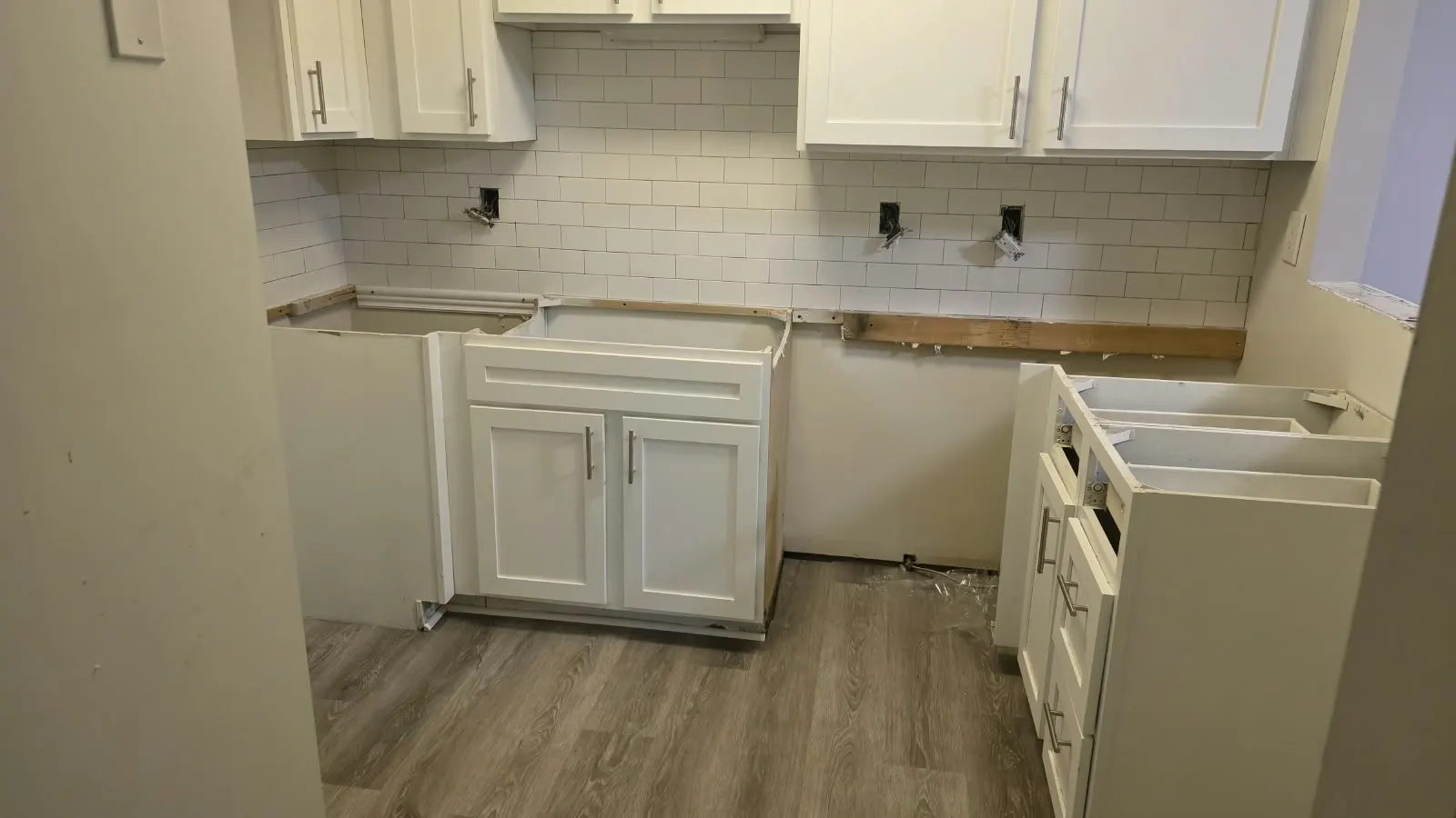 Vinyl plank flooring beside white kitchen cabinets, flooring in Hampton, VA