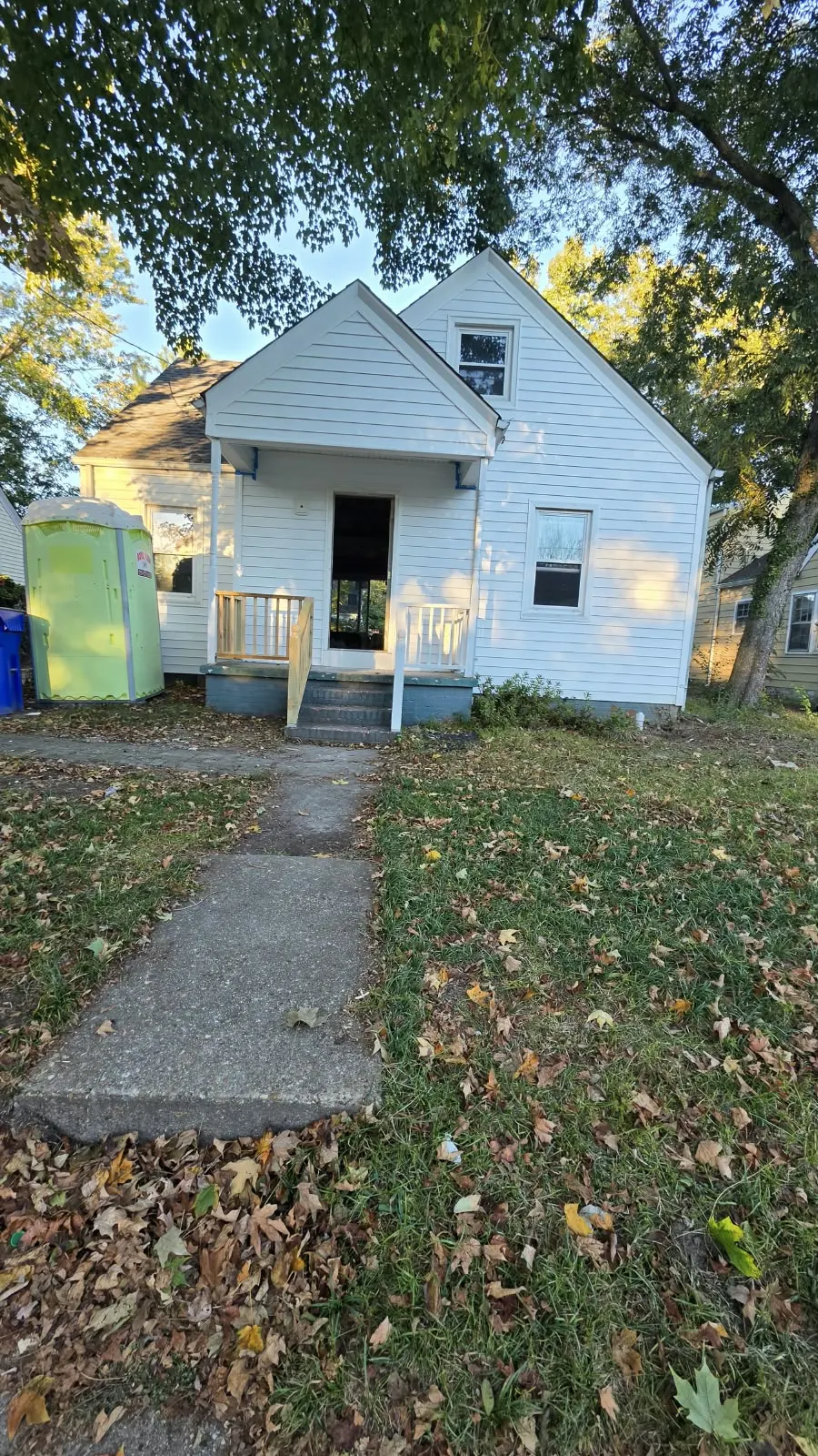 White Cape Cod house and front yard before exterior work in Hampton, VA