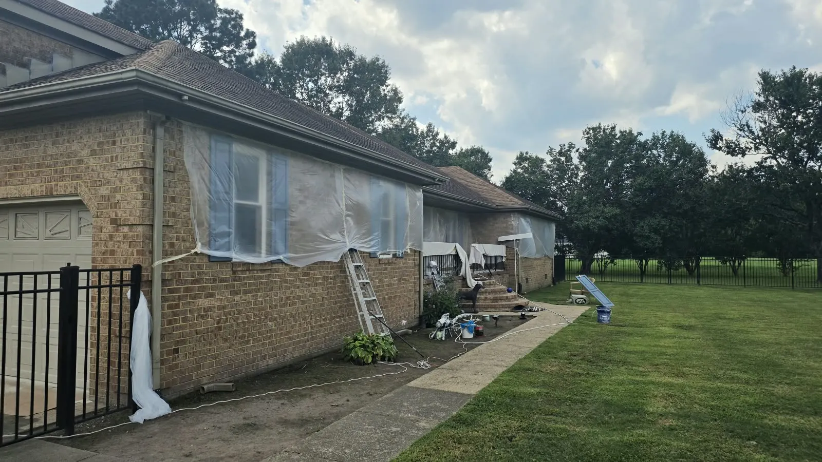 Brick house with windows masked for exterior work in Hampton, VA