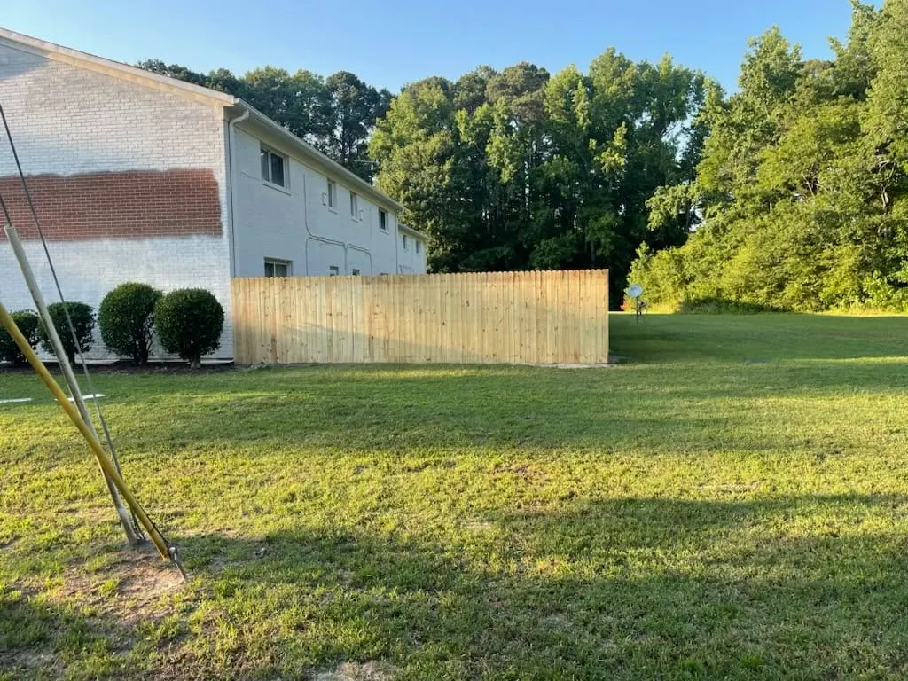Wood fence line running beside a brick building in Hampton, VA