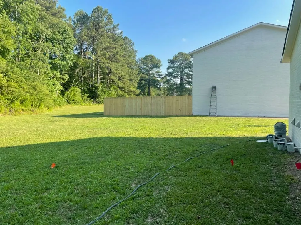 Wood fence across a green yard in Hampton, VA