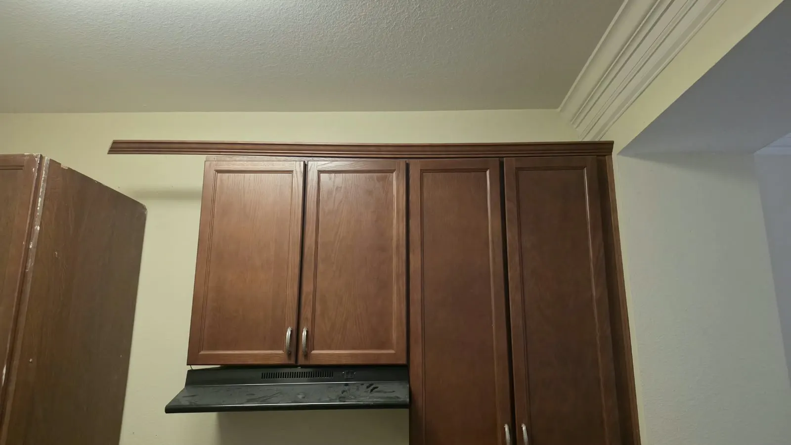 Brown kitchen cabinets before a remodel in Hampton, VA