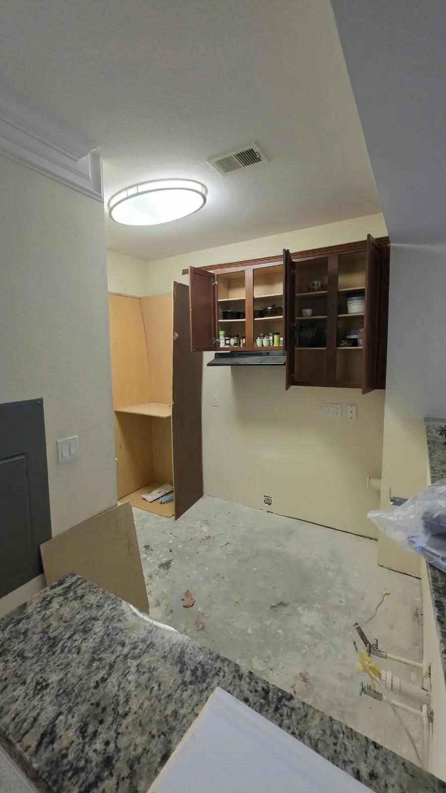 Kitchen cabinets and granite counter during installation in Hampton, VA